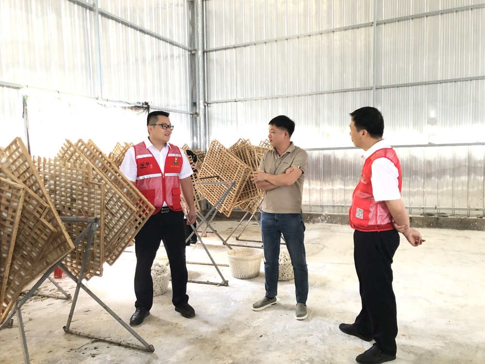 图为蒙山农商银行工作人员走访陆桂幸厂房 蒙山农商银行供图